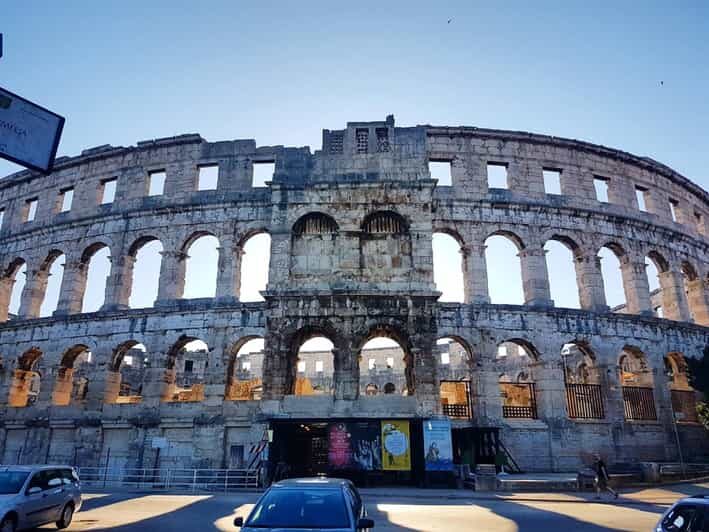Pula: Old Town Walking Tour for Foodies with Dinner and Wine - Entering Pula’s Old Town from the Amphitheater